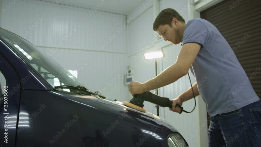 Polishing blue car with reflection, the concept car care Polishing blue car with reflection, the concept car care