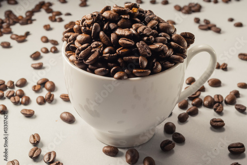 Coffebeans on Neutral Gray Background. Dark Roast Coffee. White