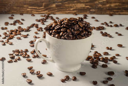 Coffebeans on Neutral Gray Background. Dark Roast Coffee. White