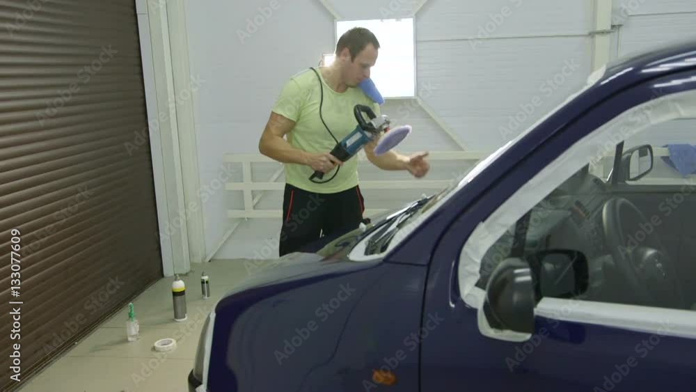 Polishing blue car with reflection, the concept car care Polishing blue car with reflection, the concept car care