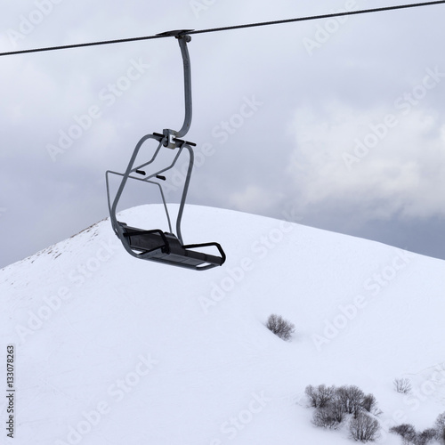 Chair lift and gray sky at evening
