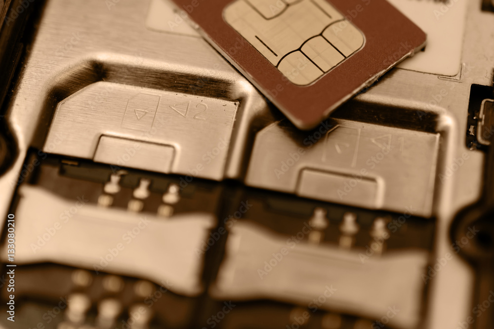 SIM card on slots in mobile phone. Two seats for the . Vintage toning. SIM card on slots in mobile phone. Two seats for the . Vintage toning.