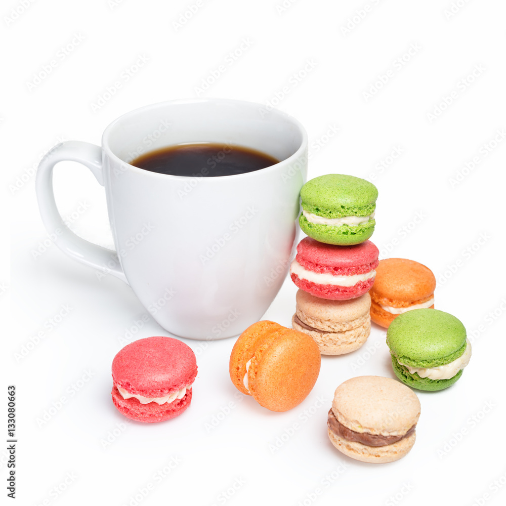 Sweet and colorful macaroons with cup of coffee on white background. Traditional french dessert macarons