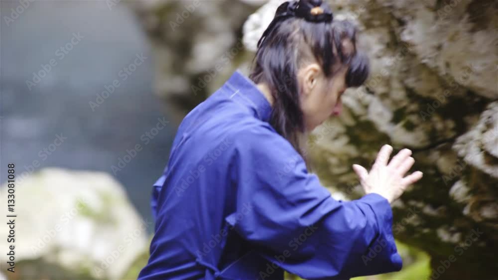 Woman in blue kimono stretch hands around making form exercise 4K
Woman in blue kimono stretch hands around making form exercise 4K