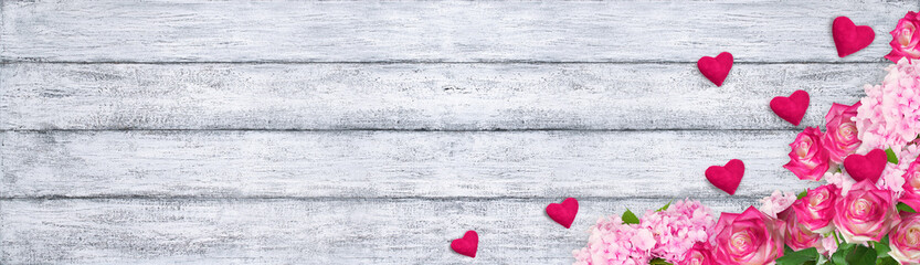 Roses and hydrangeas with hearts on background of shabby wooden
