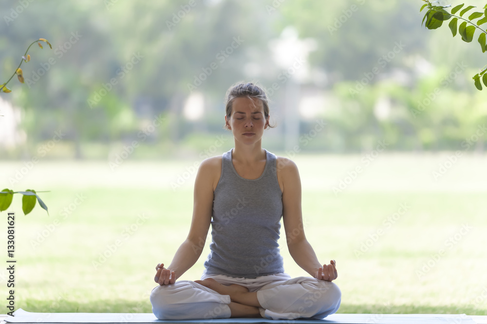 Fototapeta premium yoga girl in the summer park pose tree