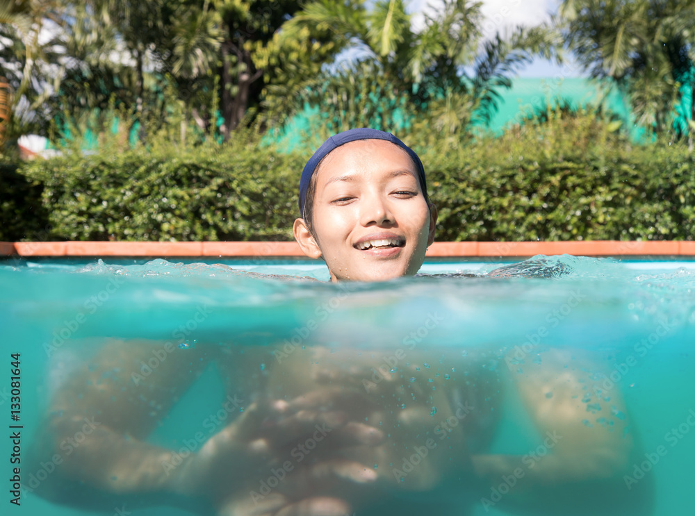 woman in a bathing cap swim in the pool