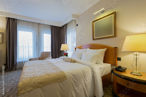 Interior of a new modern hotel double bed bedroom