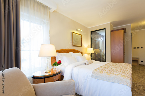 Interior of a new modern hotel double bed bedroom