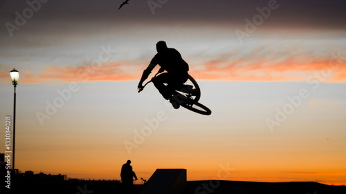 Wallpaper Mural Cyclist jumping on a sunset background Torontodigital.ca