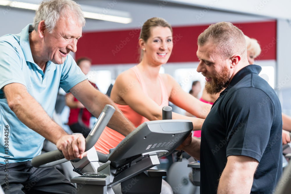 Group spinning with personal trainer in gym Group spinning with personal trainer in gym