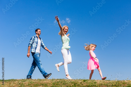 Mom and daughter walk in single file  on is jumping