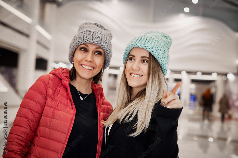 Two girls are happy becouse they have new purchases Two girls are happy becouse they have new purchases