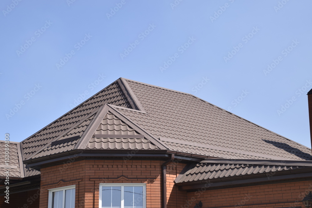 Detached house with a roof made of steel sheets. Detached house with a roof made of steel sheets.