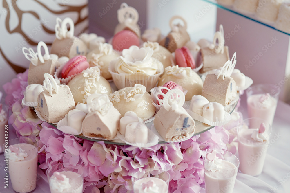 Tasty pink and white candies served on plate with hydrangeas un Tasty pink and white candies served on plate with hydrangeas un