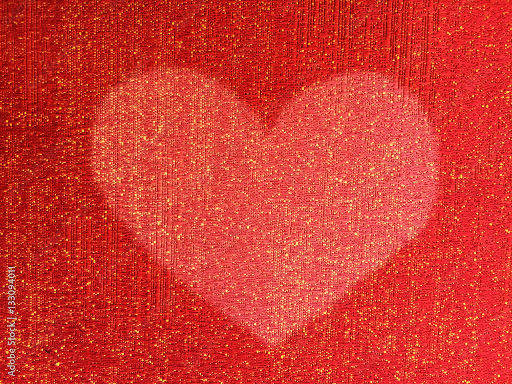 Heart shape on red fabric background texture