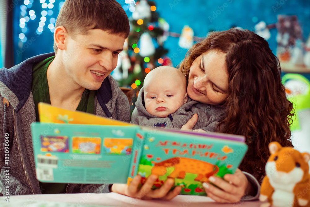 The mother,father and son reading a book The mother,father and son reading a book