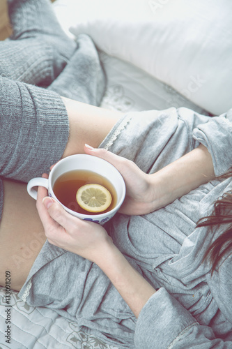 Cozy winter concept with girl drinking hot tea