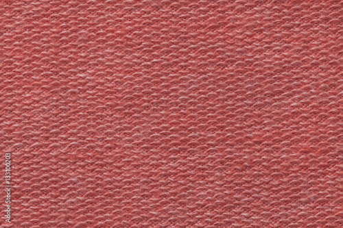 Light red background from a textile material. Fabric with natural texture. Backdrop.