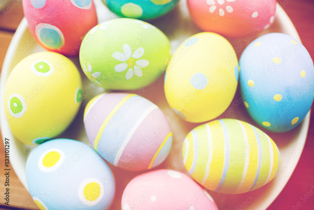 close up of colored easter eggs on plate close up of colored easter eggs on plate