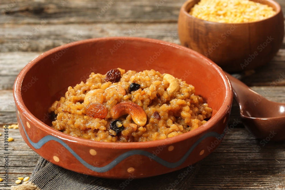 Sweet Pongal or Chakkara pongal on traditional clay pot, selective focus Sweet Pongal or Chakkara pongal on traditional clay pot, selective focus