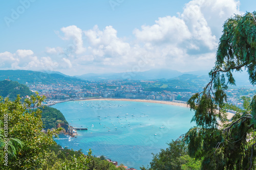 seascape with blue water, boats and the city. San Sebastian Basque Country. Ocean color image