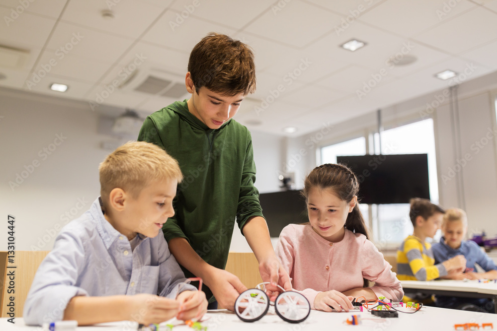 happy children building robots at robotics school