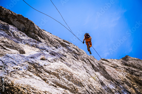 guy climber down a cliff on a rope