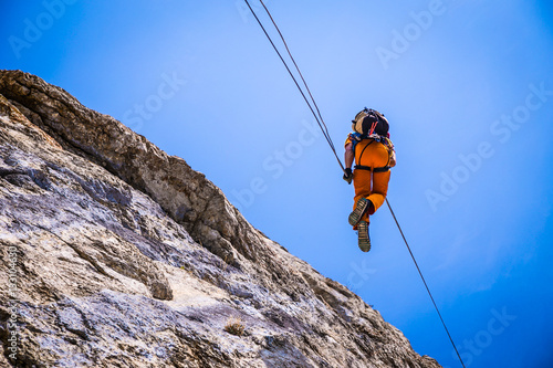 guy climber down a cliff on a rope