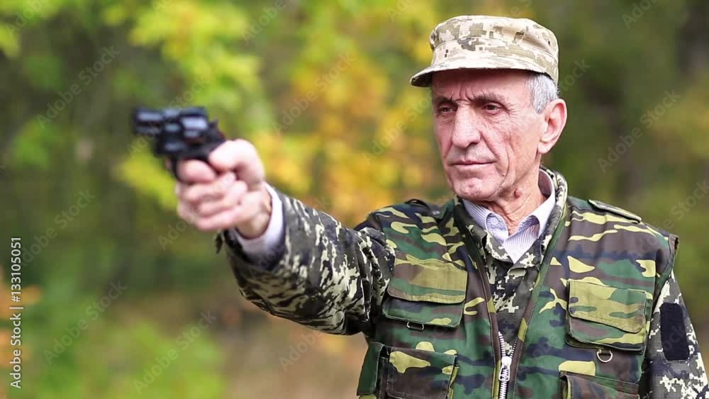 Video Stock Retired officer in military uniform shoots a revolver. Man