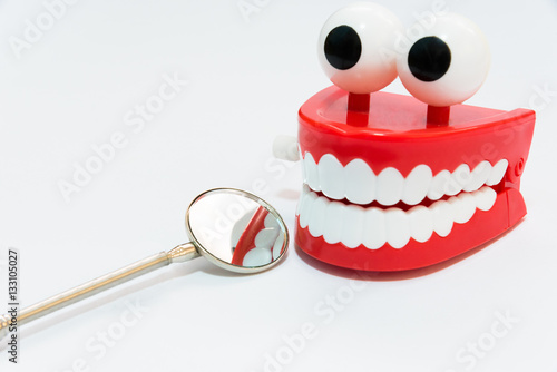 Slika na platnu Dental care concept on white background with mirror dentist tool