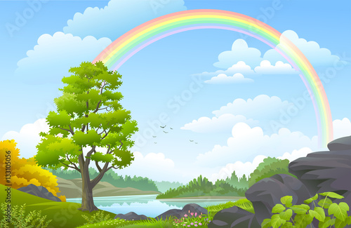 Rainbow over a landscape with forest, meadows, hills and a river