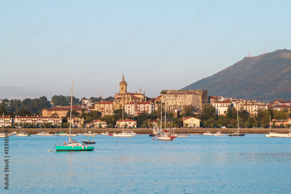 seascape of bay with blue water and yachts on the background of the city. view of the town of Irun, Spain