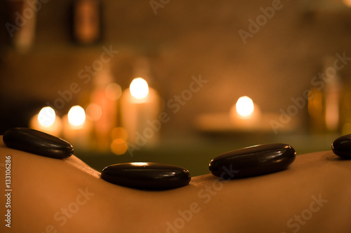 picture of woman in spa salon with hot stones