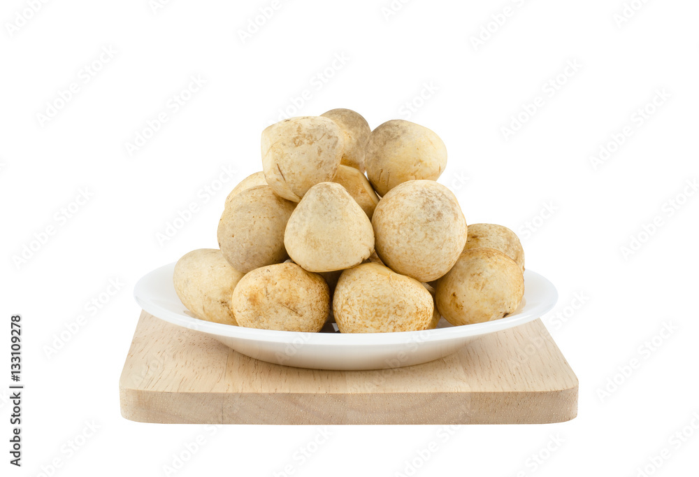 Close-up fresh straw mushrooms on white ceramic plate over wooden tray isolated on white background Close-up fresh straw mushrooms on white ceramic plate over wooden tray isolated on white background