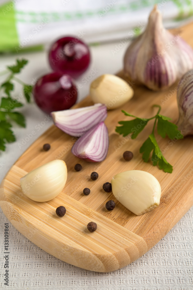Fresh garlic, onion and spices on a light background closeup Fresh garlic, onion and spices on a light background closeup