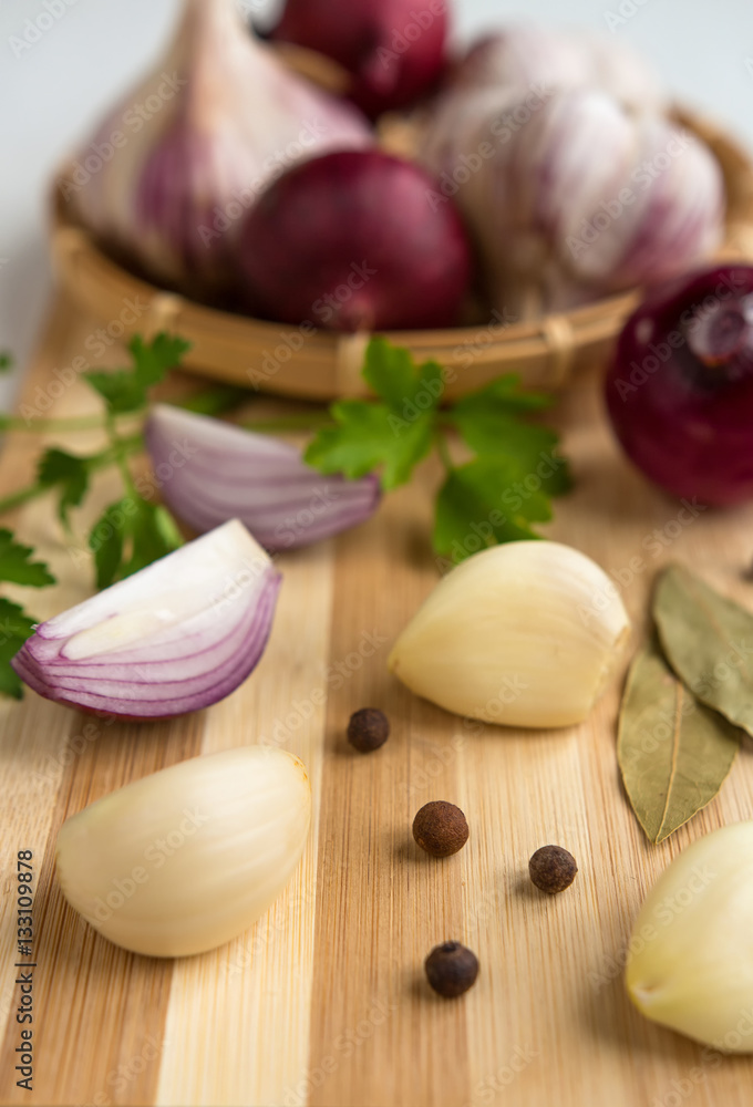 Fresh garlic, onion and spices on a light background closeup Fresh garlic, onion and spices on a light background closeup