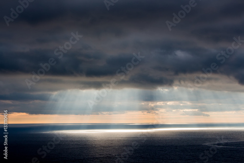 Bright sunlight over ocean, beautiful shine sun beam in sky, abstract blue natural background, peaceful skyscape, open heaven and God, morning sun rays, Mediterranean resort, panoramic sea