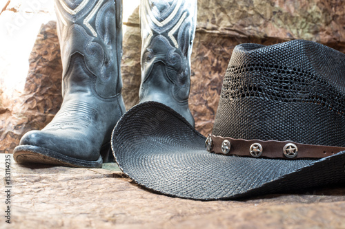 detail of black cowboy hat with blue boots