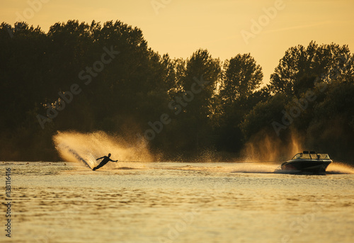 Canvas Print Man wakeboarding on lake behind boat