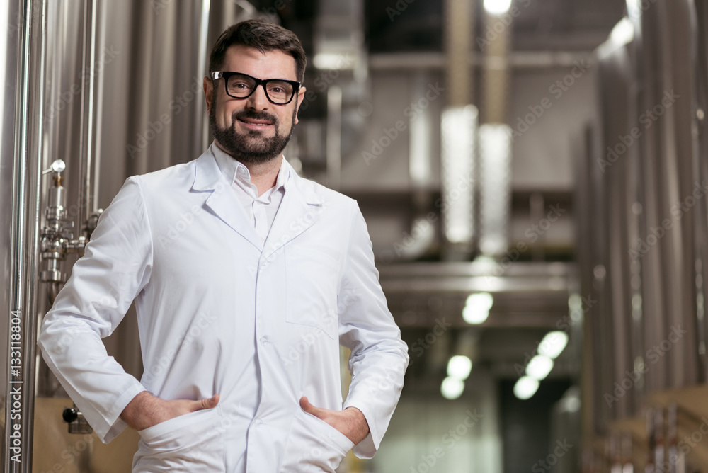 Smiling man posing with brewing mechanisms Smiling man posing with brewing mechanisms