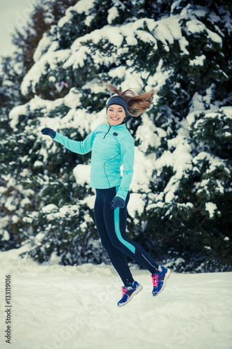 Winter sport, girl jumping in snow