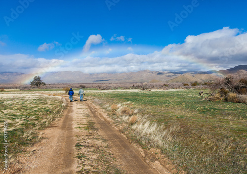men walking under rainbow © posh