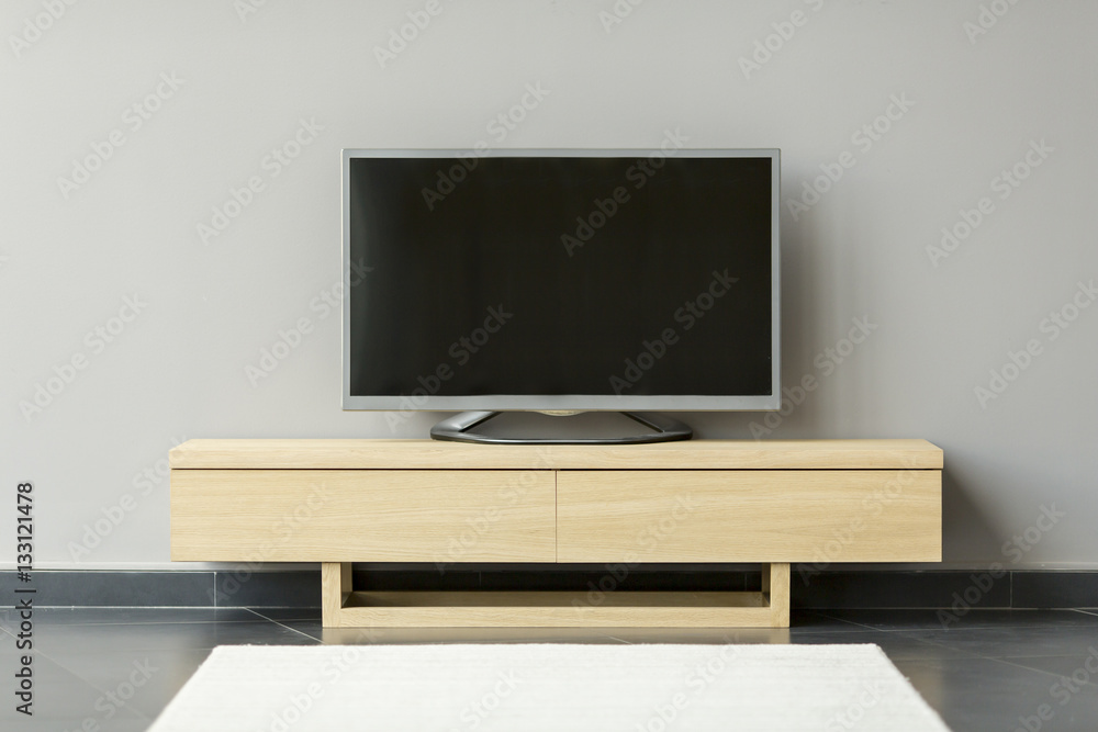 Flat-TV standing on the commode in the room Flat-TV standing on the commode in the room