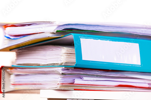 Many file folders, ring binders on office table