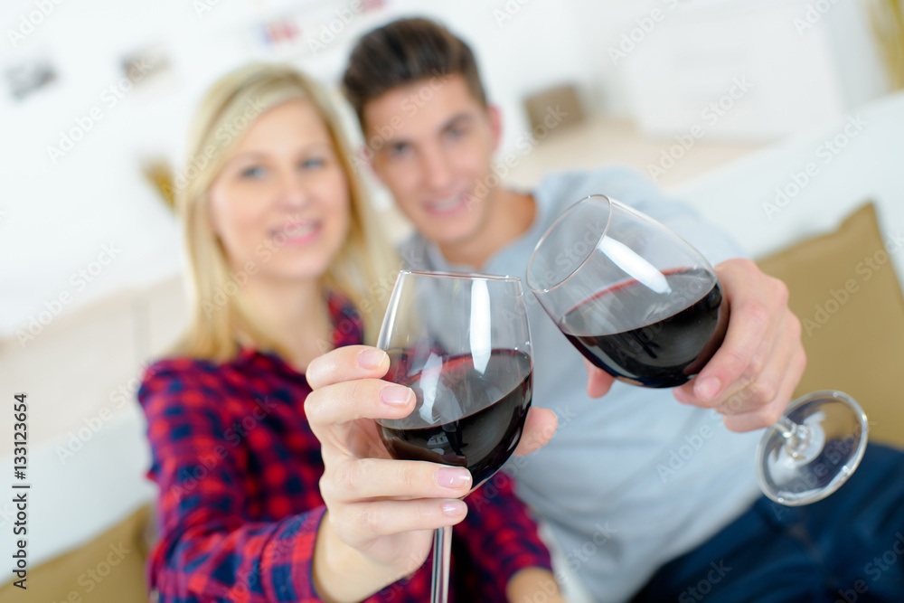 a young couple with wine glasses a young couple with wine glasses