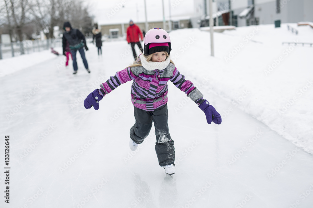 little girl enjoying ice skating in winter season little girl enjoying ice skating in winter season