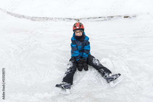 little boy enjoying ice skating in winter season
