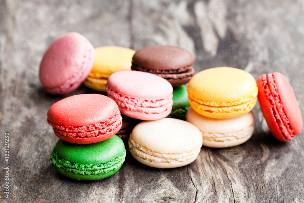 colorful macarons on rustic wooden backrgound colorful macarons on rustic wooden backrgound