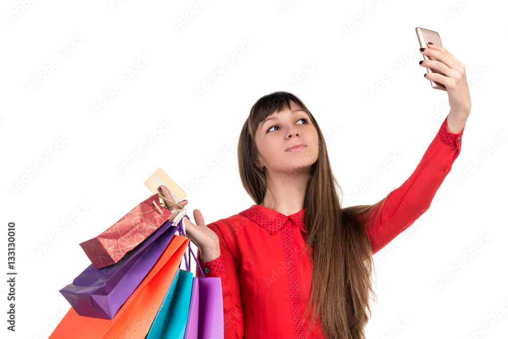 Young woman shopping with credit card holding packages doing sel Young woman shopping with credit card holding packages doing sel